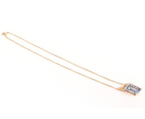 A yellow gold and aquamarine pendant, the rectangular step cut aquamarine with an approximate weight of 19 carats, suspended 