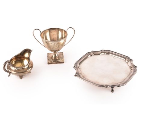 An Elizabeth II footed silver salver, hallmarked for Sheffield 1968 by Alexander Clark & Co Ltd, 23 cm diameter, a silver tro