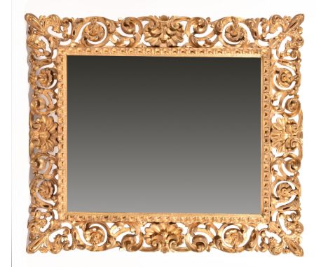 An 18th century carved gilt wood and gesso Rococo style wall mirror, the elaborate frame decorated with shells, scrolling flo