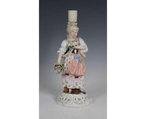 A Dresden porcelain candlestick in the form of a young woman, underglaze blue cross hatch factory mark, 25cm. high.