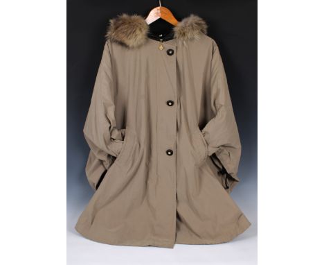 NINA RICCI poncho trench coat from her Evolution collection, in classic khaki, lined in a dark grey wool mix, featuring a bla