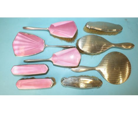 A 1930's silver and pink enamel backed five-piece dressing table set,&nbsp;comprising hand mirror, two hair brushes and two c