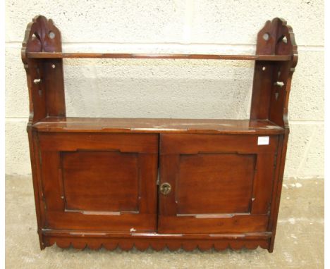 An Edwardian mahogany small two-door wall cupboard fitted with a shelf, 61cm wide, 57cm high and a&nbsp;metal-bound cabin tru