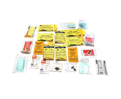 A tray of OO gauge model railway decals and parts, including Kadee mange-matic couplings, champ decals, cal-scale and othersQ