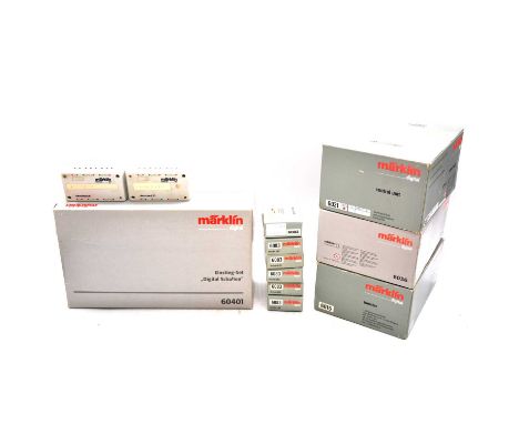 A box containing Marklin digital control units, control panels, and others, including ref. 60401 digital entry level set, mis