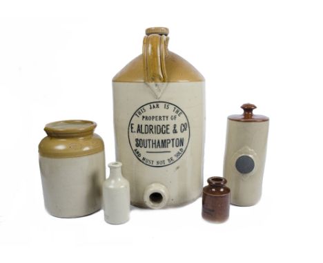 A collection of vintage stoneware jars and bottles, including a Taylor's mustard pot, two hot water bottles, an E. Aldridge S