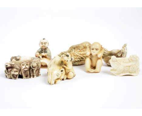 A collection of seven netsuke including rats emerging from coils of rope, a menagerie of grotesque entwined beasts and boy wi
