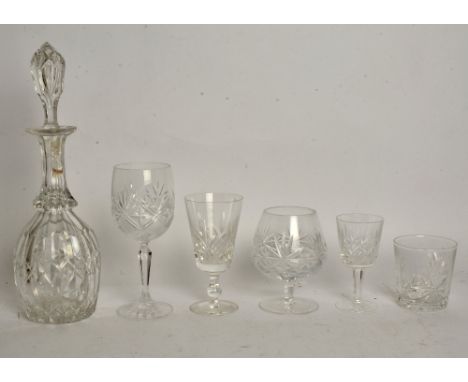 A selection of cut crystal drinking vessels and decanters, a large number of drinking vessels including whisky tumblers, bran