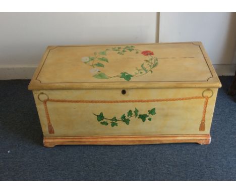 A 19th Century pine trunk, later hand painted with contemporary floral and rope decoration, two drawers and a candle box fitt