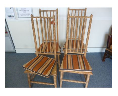 A set of four 19th Century hardwood bobbin turned side chairs, with caned seating, striped cushions and tassels (4)