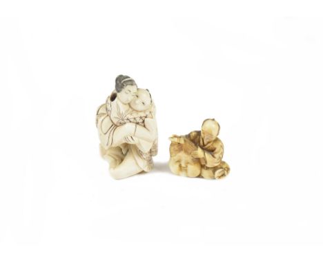 Two late 19th/early 20th Century Japanese ivory netsuke, one modelled as a couple embracing, marked to the base, the other se