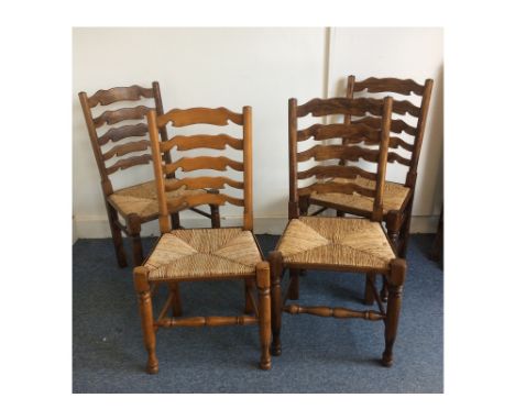 A trio of stained beech contemporary rush seat ladder back chairs, together with a similar example (4)