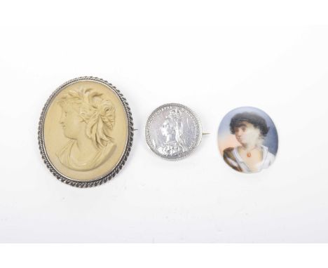 A lava cameo brooch
Together with, a coin brooch and an unmounted ceramic cameo (3)