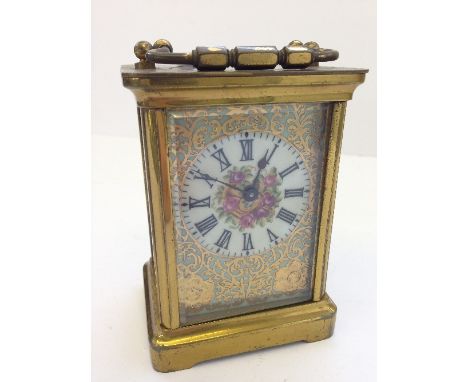 An enamel decorated glass and brass cased carriage clock.