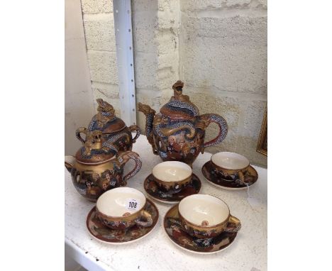 The residue of an early 20th century Satsuma tea service comprising teapot, milk jug and sugar basin and cover together with 