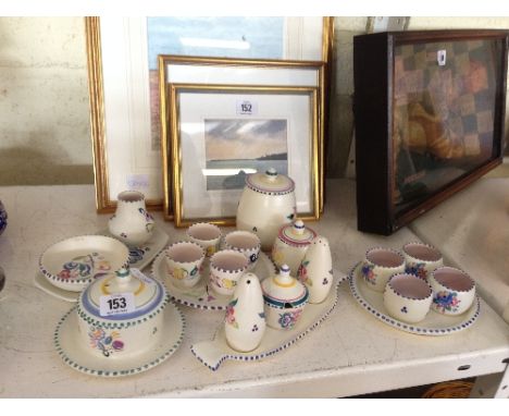 A collection of various white bodied Poole Pottery items including cruet sets, jam pots and other small items.