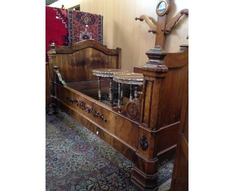 A 19th century mahogany sleigh bed with carved sides.