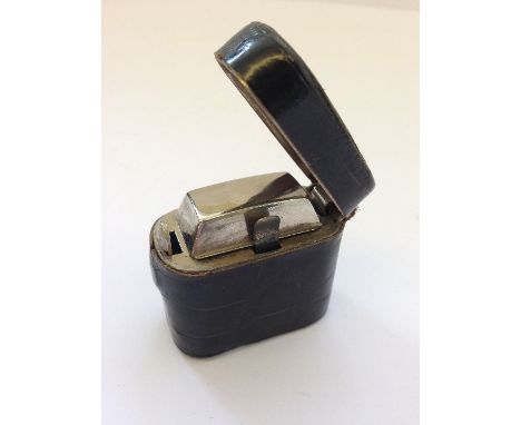 An early 20th century Crocodile leather cased travelling inkwell.