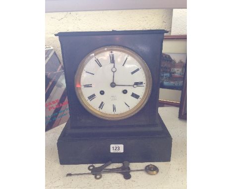 A 19th century slate cased mantle clock by Dent, 61 Strand, London.