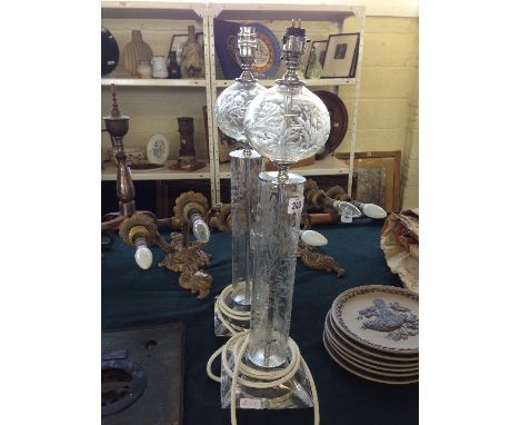 A pair of floral engraved glass column electric lamp bases.