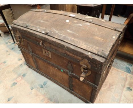 Large antique dome top canvas and wood bound luggage trunk with original Collins and Graham of Dublin label L: 84 cm 