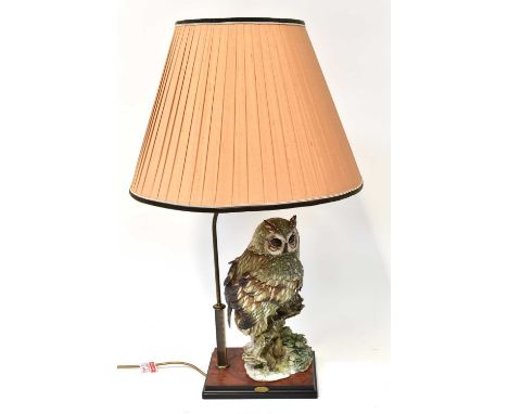 A Giuseppe Armani Florence Capodimonte standard lamp, modelled with an owl perched on a branch, on a walnut-effect base, with