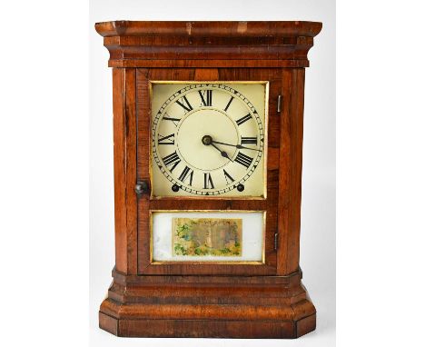 An early 20th century eight-day walnut cased mantel clock, the white enamelled dial set with Roman numerals, with twin drum m