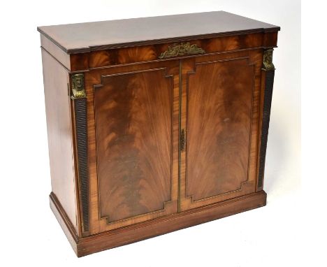 A reproduction mahogany hi-fi cabinet, the crossbanded top above pair of panelled doors, flanked by caryatid figures and rais