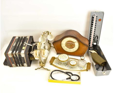 A collectors' lot to include a 1930s oak cased mantel clock, a glass and gilt metal four-piece dressing table set, an early 2