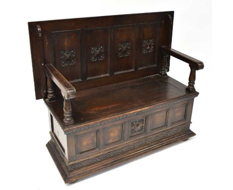 An early 20th century oak monk's bench, the lower section with storage compartment, raised on squat bun feet, when closed 72.