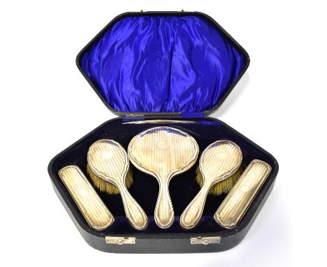 I. S. GREENBERG &amp; CO; a George V hallmarked silver six-piece dressing table set, comprising comb with horn teeth, a hand 