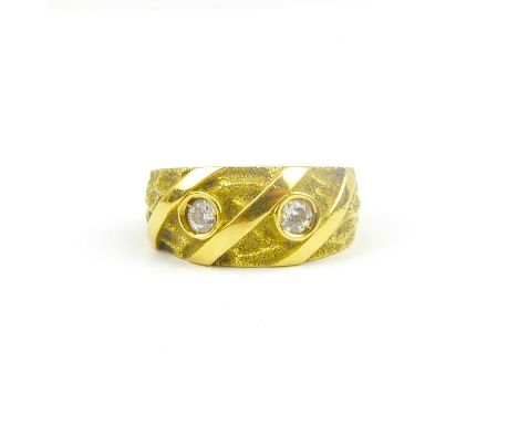 An Egyptian yellow gold ring set with two bezel set white stones, indistinctly marked, size M, approx. 4.8g.Condition Report: