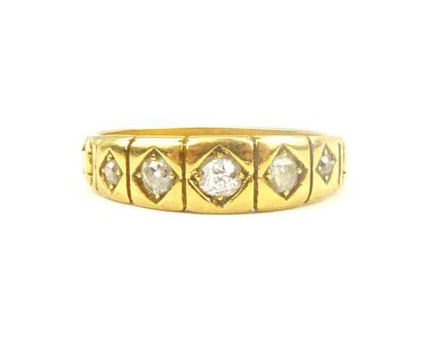 An 18ct gold ring with five flush set graduated small diamonds, size O, approx. 3.7g.