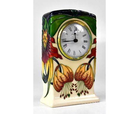 MOORCROFT; an 'Anna Lily' pattern mantel clock, the white enamel dial with Roman numerals, copyright backstamp for 1998, heig