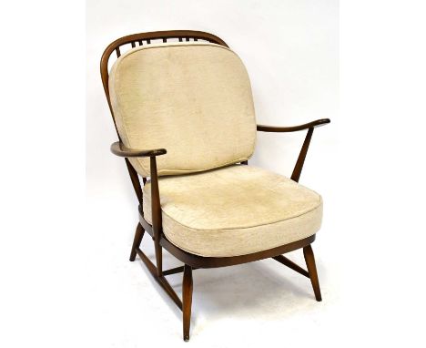 ERCOL; a pair of dark elm stick back open armchairs upholstered with cream cushions, on tapering legs (2).