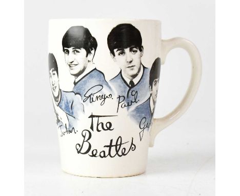 THE BEATLES; a c.1960s Tams Ltd mug featuring black and white images of the band in blue-grey suits, on a cream ground, heigh