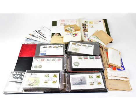 A quantity of first day covers contained within three albums and a quantity of loose examples.