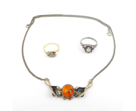 A gold ring set with three tiny diamonds, size G, a silver ring, and a silver and amber necklace.