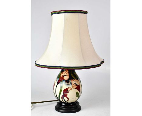 MOORCROFT; a cream ground floral table lamp raised on circular base, height including fitment 29cm.Condition Report: - This l