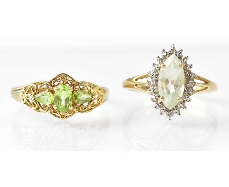 A 9ct gold three-stone peridot ring with filigree decoration to the shoulders, size T, a 9ct gold ring with quartz stone surr