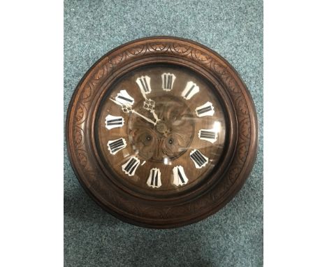 FRENCH CIRCULAR WALL CLOCK, two train eight day movement, the carved oak dial with applied enamel Roman numerals, in a carved