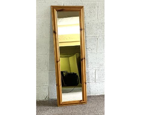 A rectangular pine framed wall mirror; together with a modern camel saddle and two small modern folding tables (4)