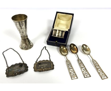 A silver napkin ring, cased; together with two silver spirit labels for brandy &amp; whisky; also a plated tot measure and th