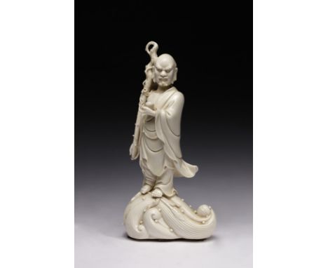 Chinese Art A Blanc de Chine figure of Li Tieguai ImmortalChina, Qing dynasty, 19th century . . Cm 27,50. A white porcelain s