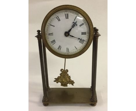 BRASS MANTEL CLOCK - drumhead mantel clock with ceramic dial, roman numeral markers and bouquet pendulum on a four pillar bra