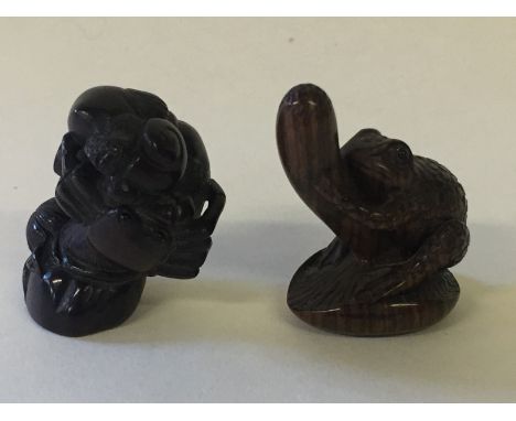 NETSUKE - two carved Meiji period wooden netsuke. To include a detailed frog on a branch measuring 4.5cm (signed to base) and