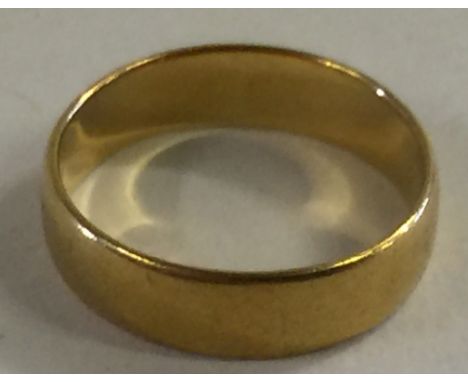 22CT GOLD WEDDING RING - with clear hallmarks for Birmingham. Weighs 3.7g. Size M/L. In blue velvet ring box.