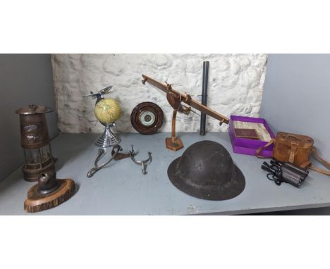 A mixed lot to include a WWI British Periscope dated 1917, Steel Brodie style helmet, spurs and others to include a globe, mo