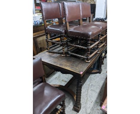 An early 20th century oak draw leaf table and six chairs in the 17th century style, the table having shaped apron and bobbin 