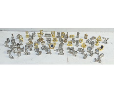 A collection of approx 70 miniature novelty quartz clocks in various forms to include Ship, Car, Pipe, Post Box, and others L